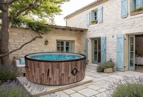 Jacuzzi rond dans une cour en pierre.