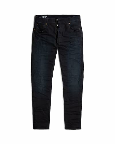 Jeans slim noirs sur fond blanc.