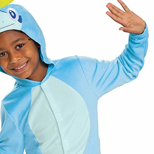 Enfant souriant en costume de dinosaure bleu
