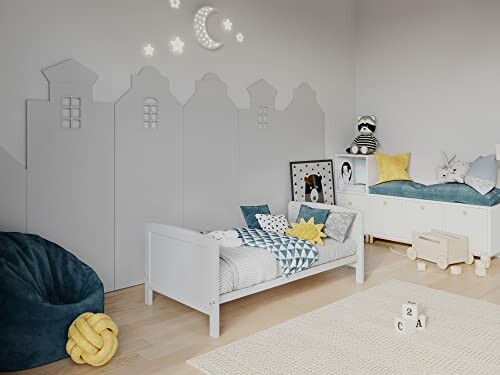 Chambre d'enfant avec lit, coussins et décoration murale étoilée.