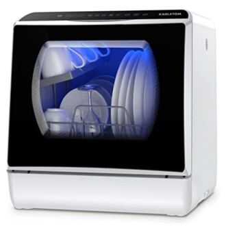 Lave-vaisselle compact sur un comptoir avec porte transparente.
