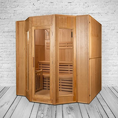 Sauna en bois d'angle contre un mur en briques blanches.