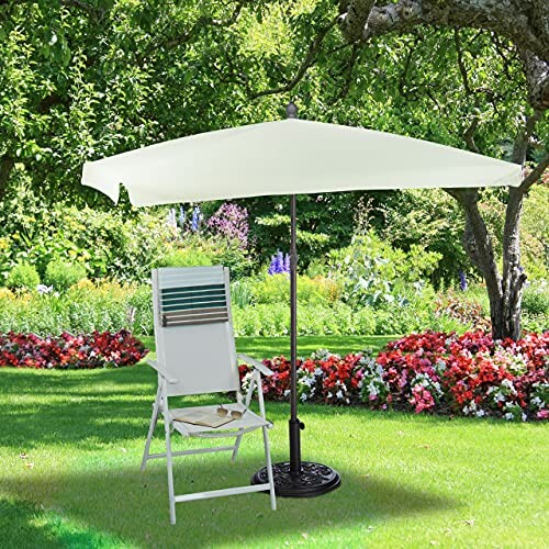 Chaise de jardin sous un parasol dans un jardin fleuri