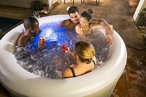Quatre personnes dans un jacuzzi avec des boissons.