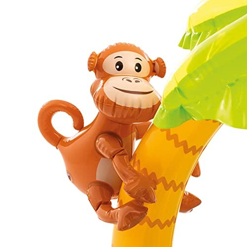 Singe gonflable grimpant sur un palmier.