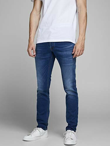 Homme portant un jean bleu et un t-shirt blanc.