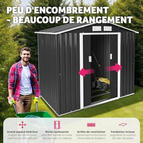 Abri de jardin en métal avec porte coulissante et outils à l'intérieur.