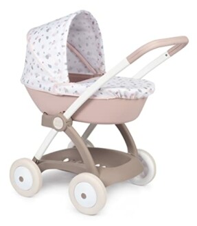 Poussette rose pour bébé avec capote à motifs.