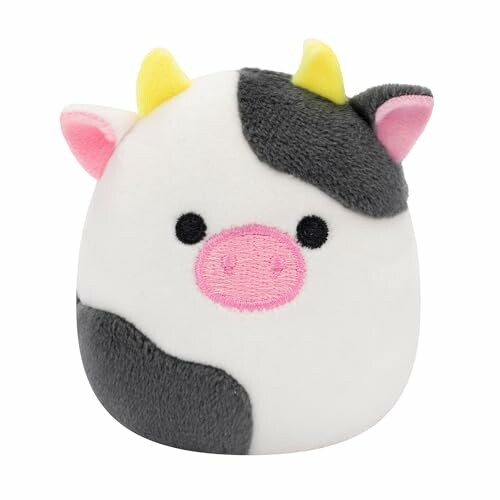 Jouet en peluche de vache avec cornes jaunes.