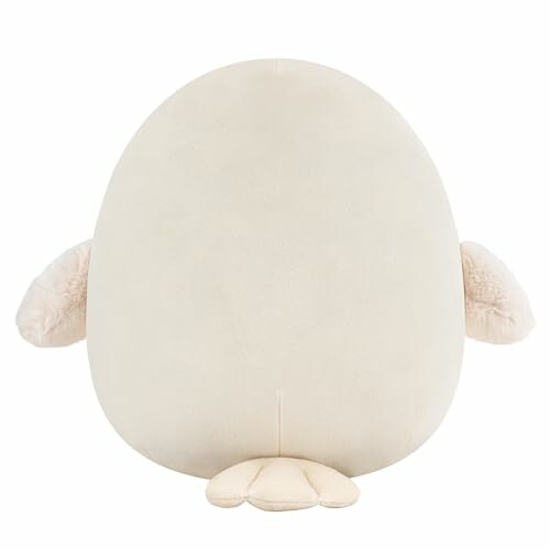 Coussin peluche en forme d'oiseau beige.