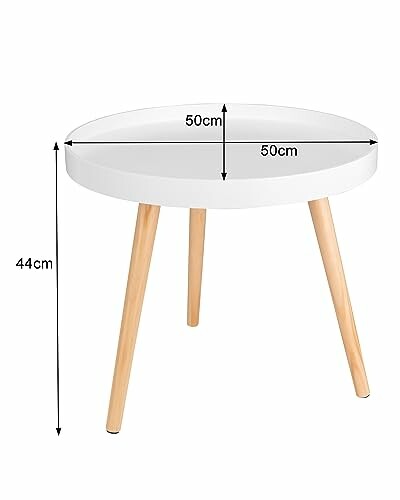 Table basse ronde blanche avec pieds en bois.