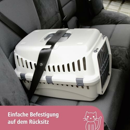 Transporteur pour animaux sécurisé sur un siège de voiture.