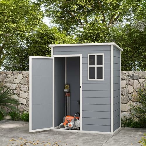 Abri de jardin gris avec porte ouverte.