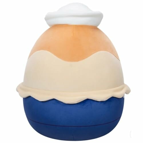 Peluche en forme de dessert avec des couleurs crème, orange et bleu.