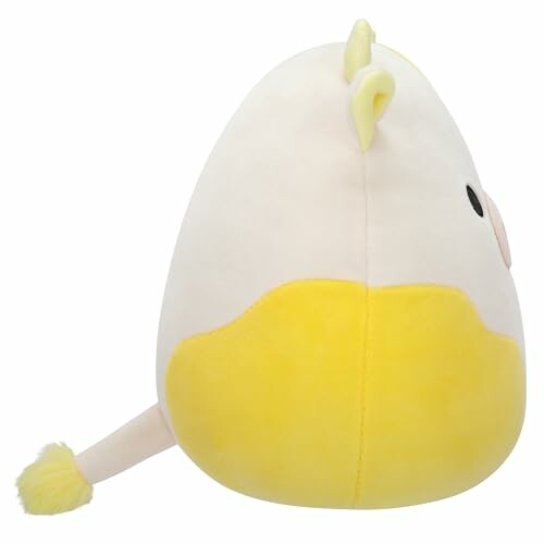 Vue latérale d'une peluche jaune et blanche.