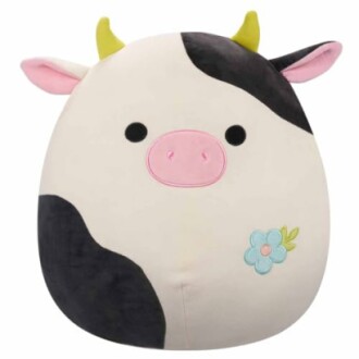Jouet en peluche en forme de vache avec cornes jaunes et fleur.