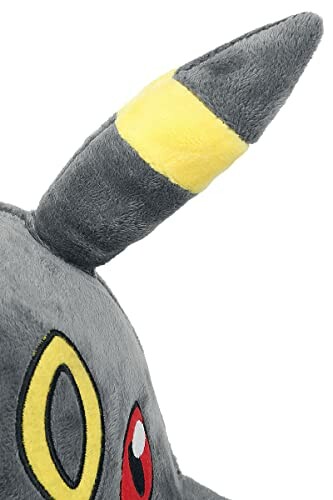 Oreille en peluche d'un Pokémon gris avec motif jaune