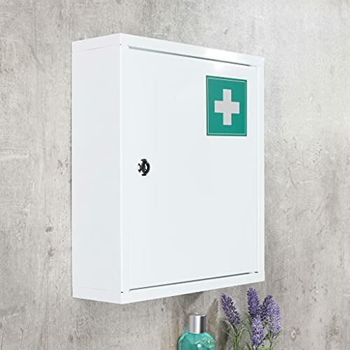 Armoire à pharmacie blanche avec croix verte sur le mur.