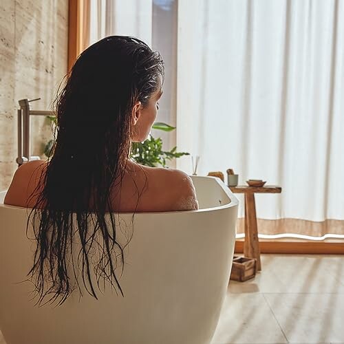 Femme se relaxant dans une baignoire.