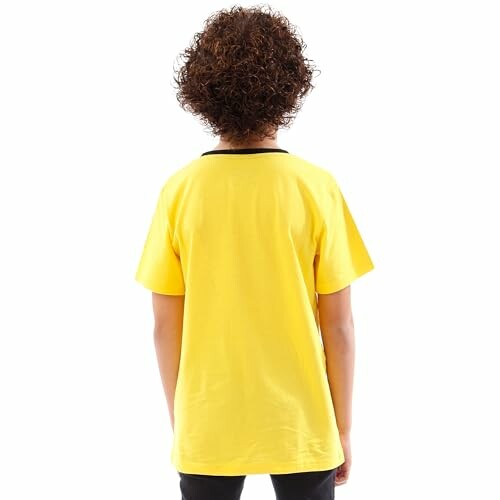 Vue arrière d'un enfant portant un t-shirt jaune.